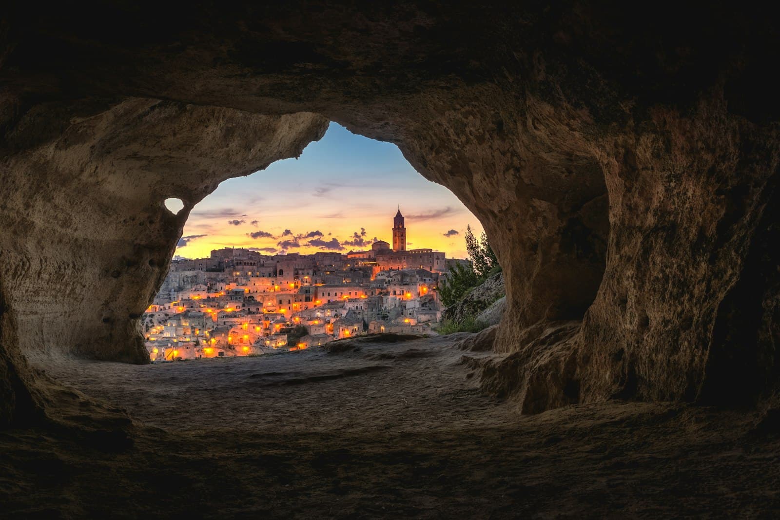 The sassi of Matera at dusk, seen from a cave mouth, Basilicata, Italy