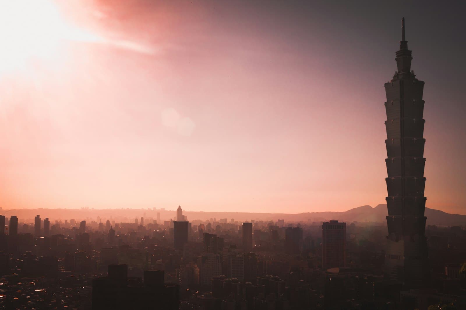 Taipei 101 rising over the city skyline at golden hour, seen from Xiangshan, Taiwan
