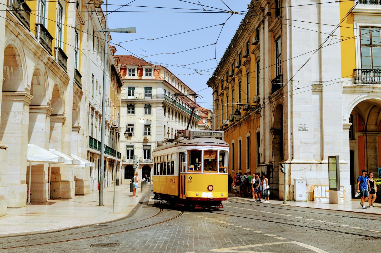 A yellow tram in Praca do Comercio, Lisbon, Portugal